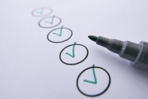 a marker near checked circles on white paper