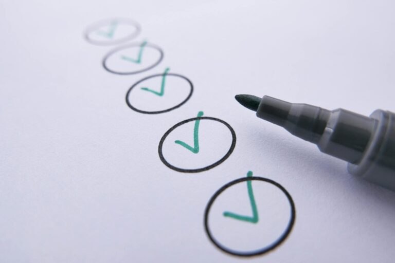 a marker near checked circles on white paper
