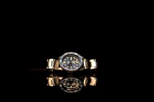 elegant gold watch with black dial reflection