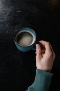 a person holding a cup of coffee