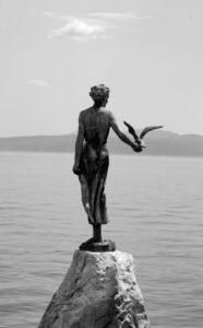 a grayscale of the maiden with the seagull statue
